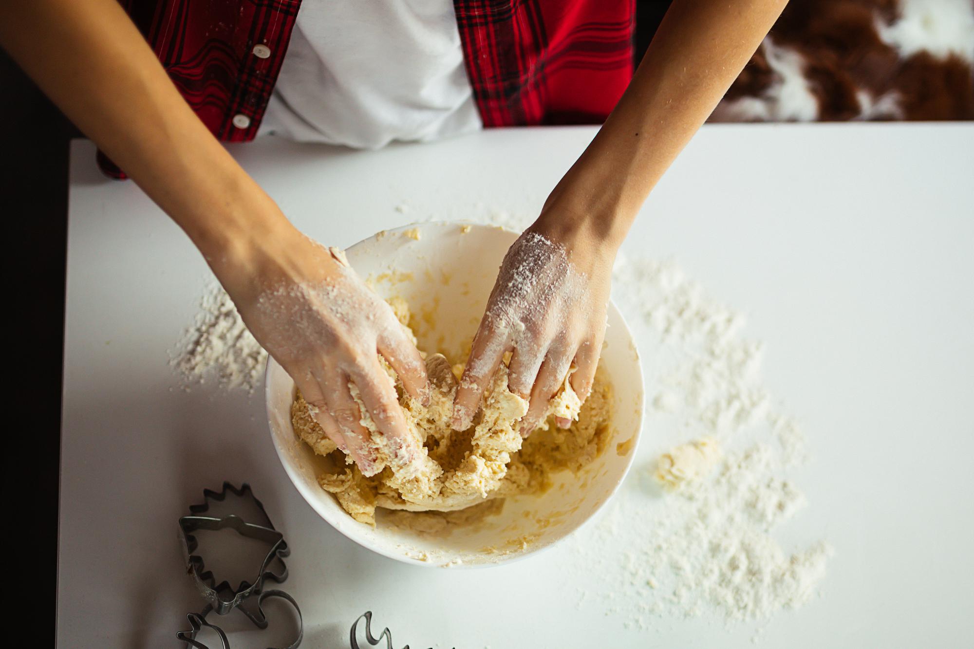 Baking technique demonstration with dough on bench